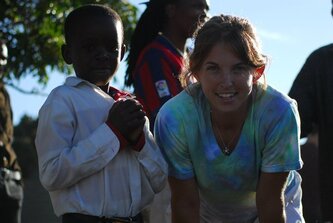 Lea MacKinnon MD Director of Health Education with a child